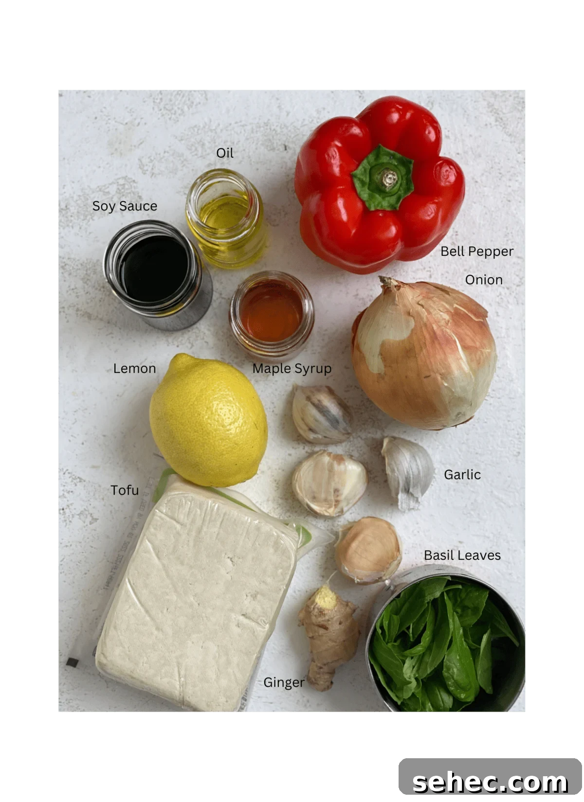 Lemon Basil Tofu Recipe with Crispy Edges 3 ingredients for Lemon Basil Tofu on a white surface