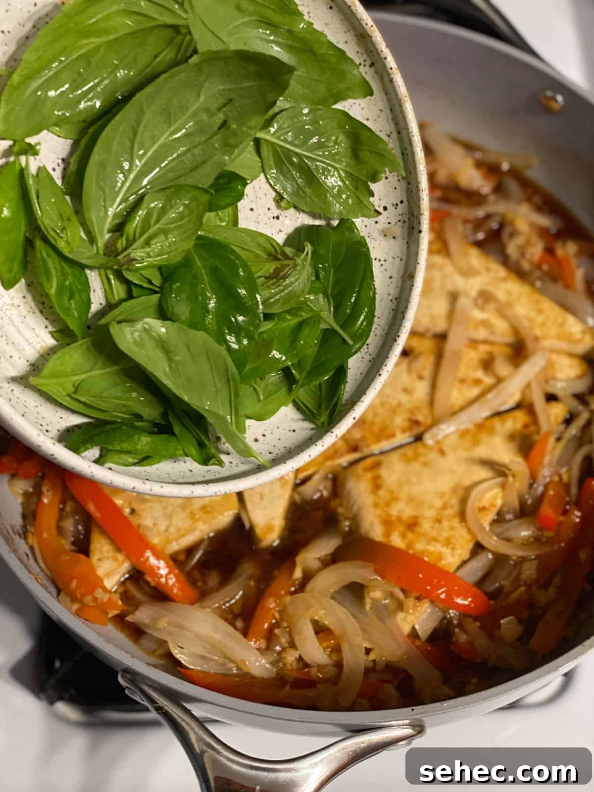 Lemon Basil Tofu Recipe with Crispy Edges 8 process of adding basil to pan