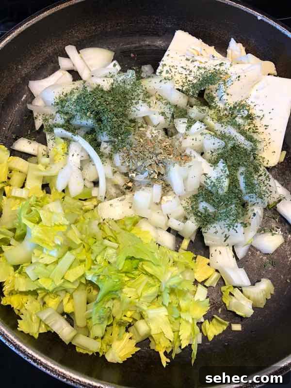 Classic Bread Stuffing Recipe for Thanksgiving 5 celery onion butter and herbs in pan ready to saute