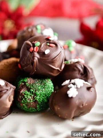 A pile of chocolate truffles on a fluted plate.