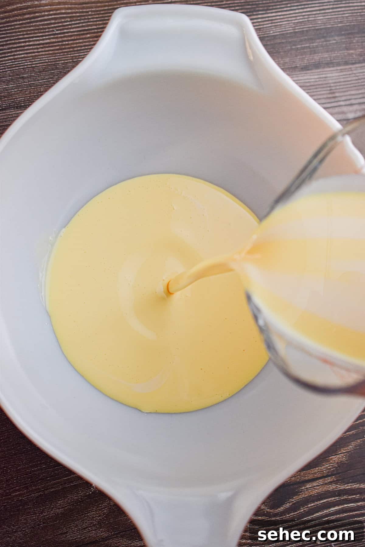 Eggnog Cream Pie Recipe for the Holidays 5 The eggnog is being poured into a large mixing bowl.