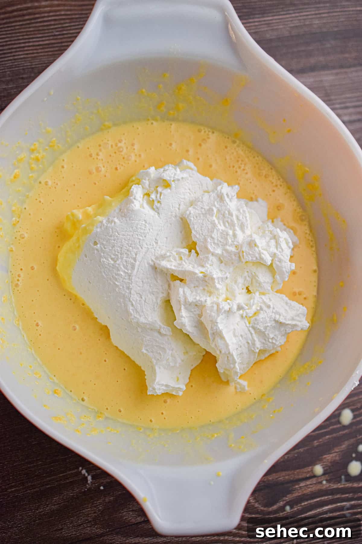 Eggnog Cream Pie Recipe for the Holidays 7 The whipped cream is added to the eggnog mixture.