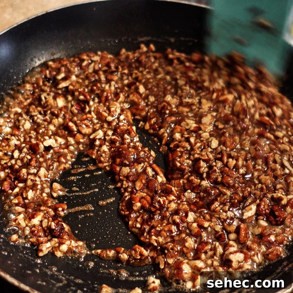 Gluten Free King Cake Recipe for Mardi Gras 8 praline pecan filling in nonstick skillet.