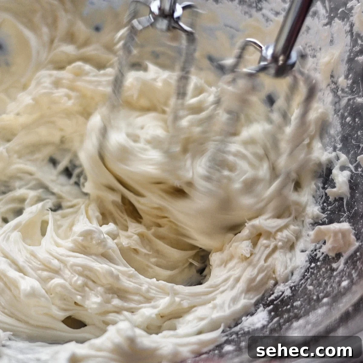 Gluten Free King Cake Recipe for Mardi Gras 9 beating cream cheese filling in small glass bowl.