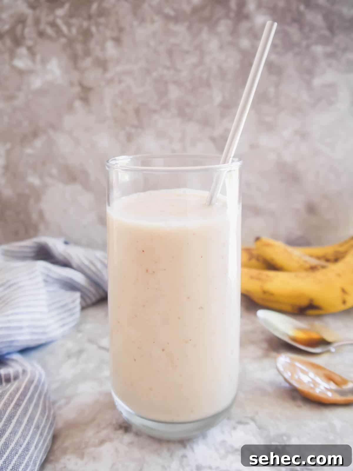 Maple Banana Yogurt Smoothie 5 Banana maple smoothie in a glass with a straw.