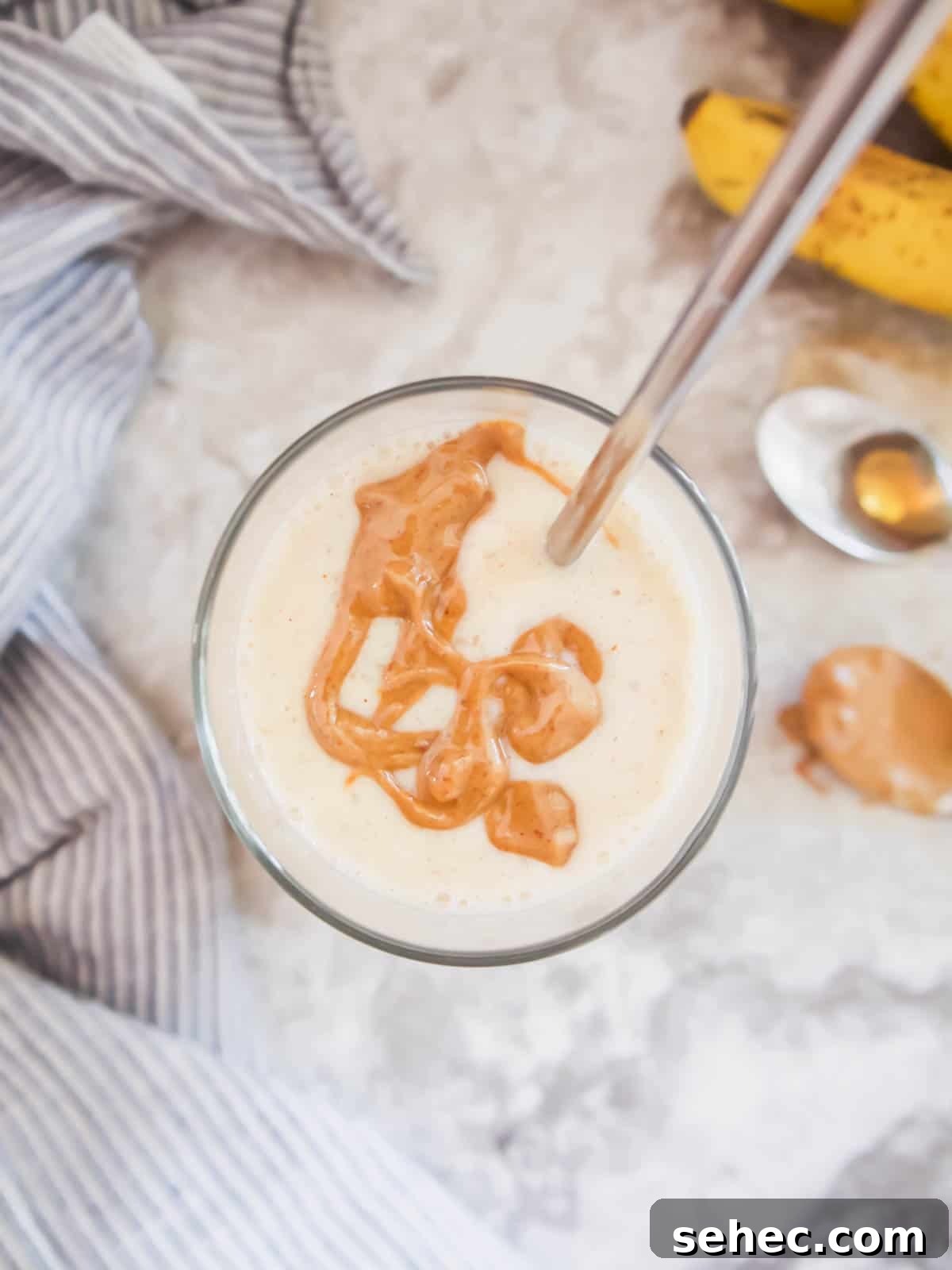 Maple Banana Yogurt Smoothie 6 Maple syrup smoothie with almond butter drizzled on top.