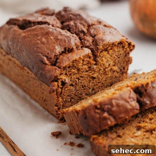 Pumpkin banana bread with several slices cut.