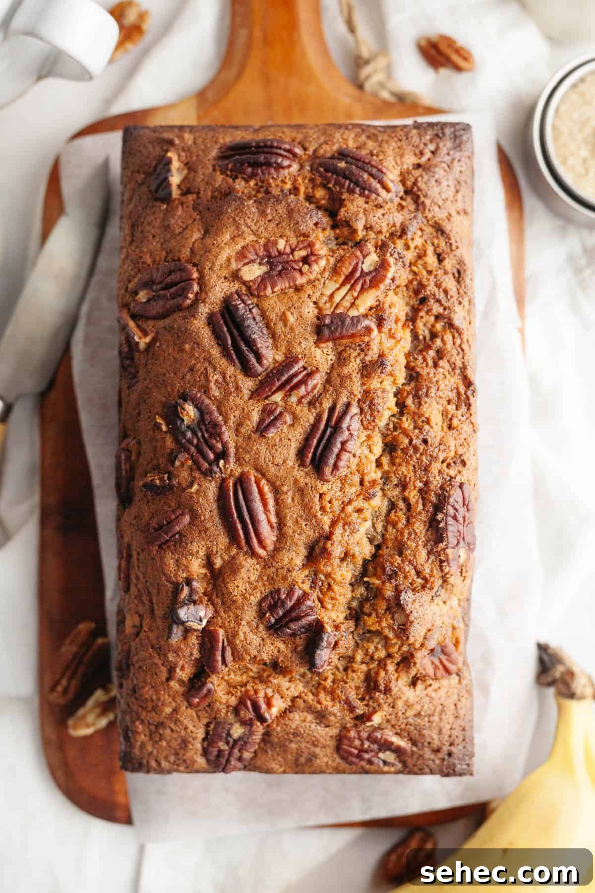 One Bowl Brown Butter Cinnamon Banana Bread with Pecans 9 Baked banana bread with pecans in a loaf pan.