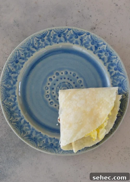 Bacon Egg and Cheese Tortilla Breakfast Wrap 6 Bacon egg and cheese tortilla folded using the tortilla hack method.