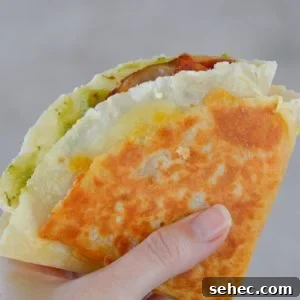 Bacon Egg and Cheese Tortilla Breakfast Wrap 8 Bacon Egg and Cheese Tortilla breakfast wrap with egg, bacon, cheddar and avocado.