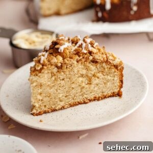 Brown Butter Cardamom Almond Cake Recipe 17 A slice of cardamom almond cake with streusel on a small plate.