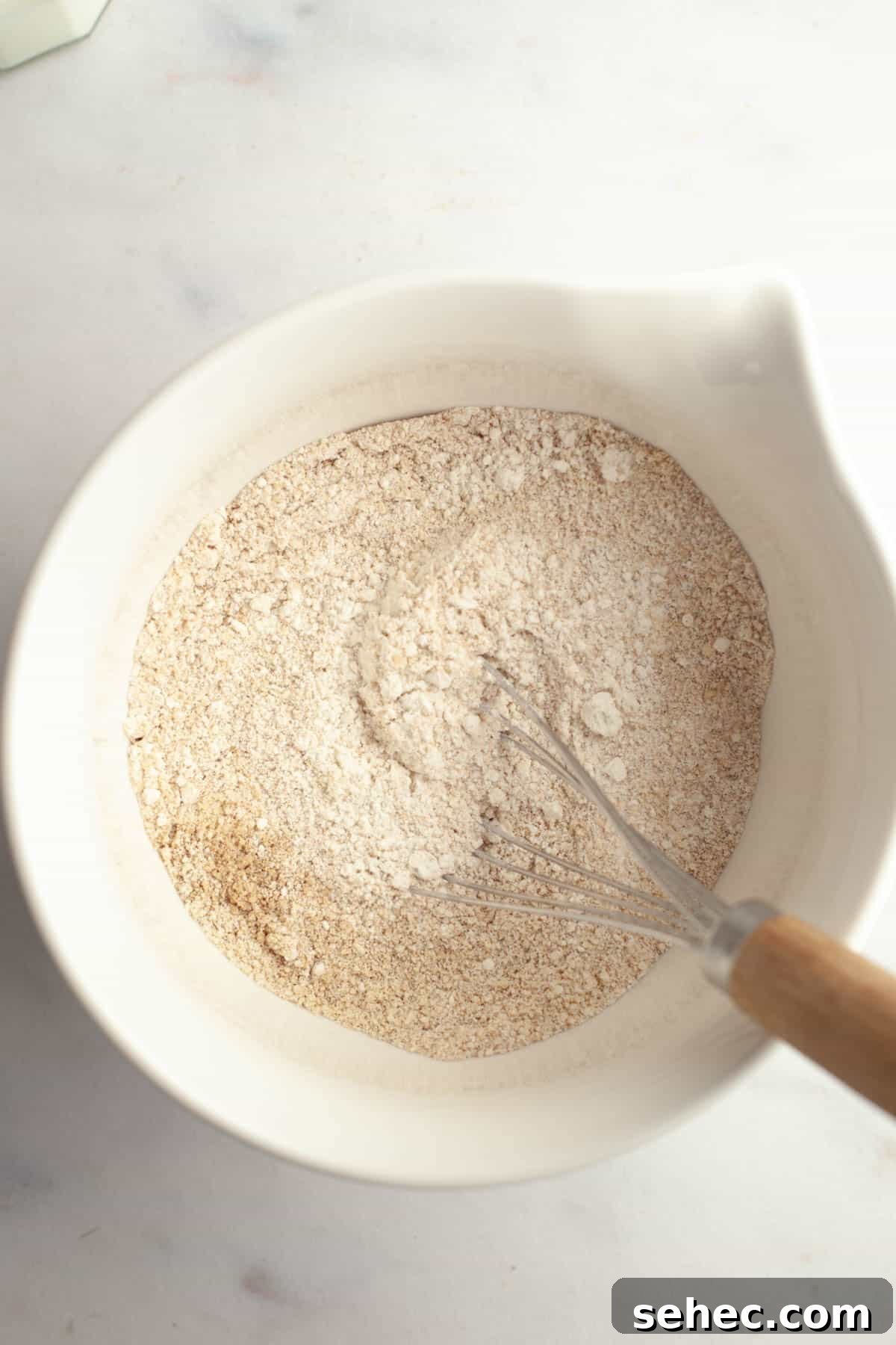 Brown Butter Cardamom Almond Cake Recipe 7 A large white bowl with whisked flour, almond flour, and cardamom.