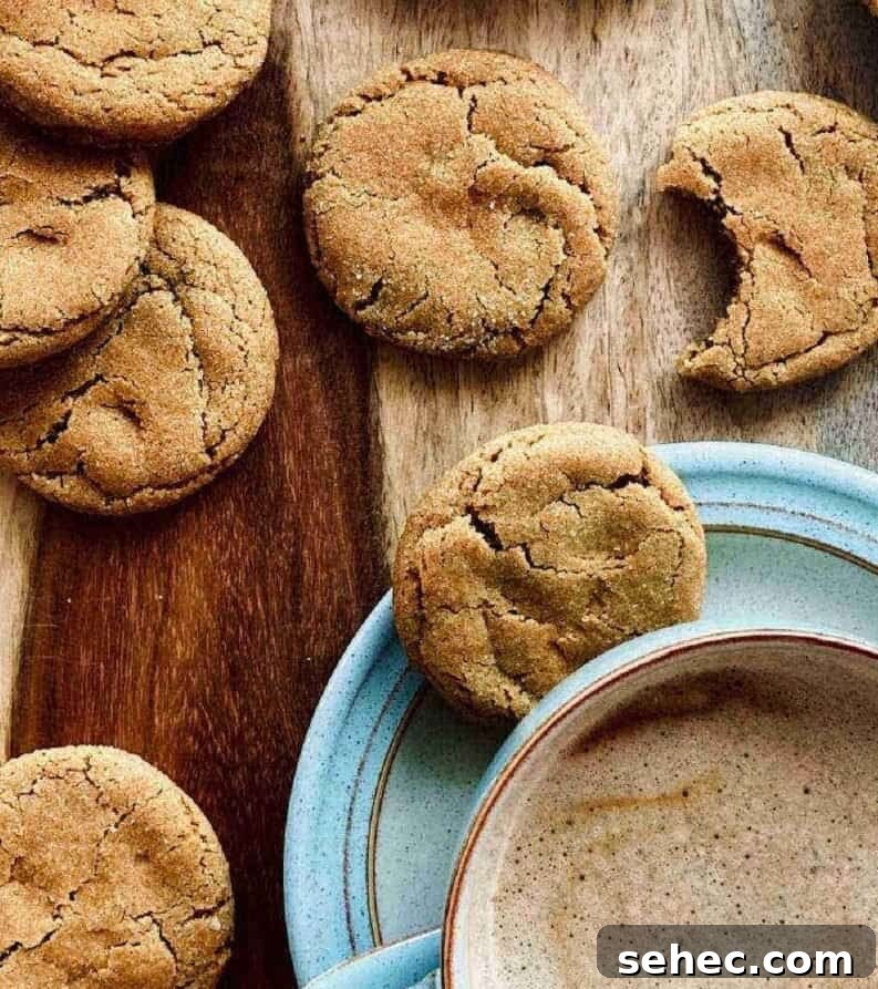 19 Big Batch Cookie Recipes for Parties and Crowds 14 Ginger cookies on a counter with a cup of coffee in a blue mug and saucer.