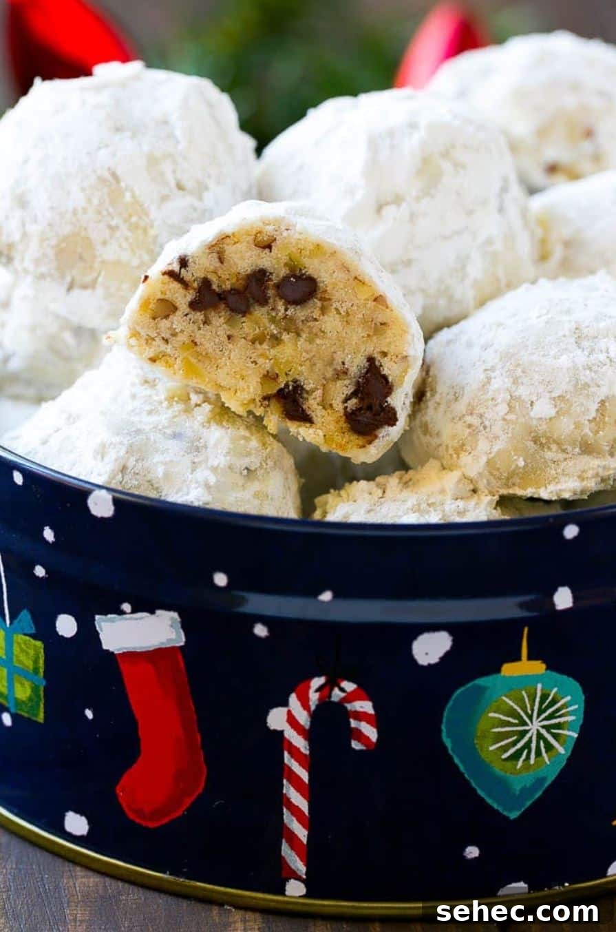 19 Big Batch Cookie Recipes for Parties and Crowds 16 Snowball cookies with chocolate chips in a Christmas tin.