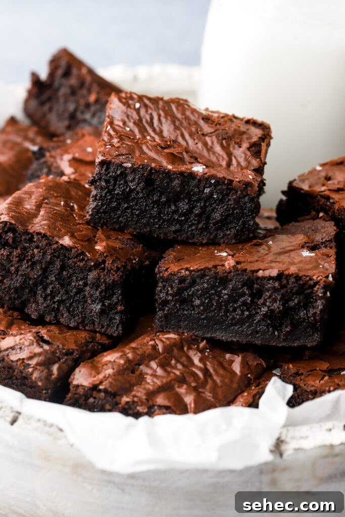 Fudgy Brown Butter Brownies with Crackly Tops 12 brown butter brownies stacked in a plate
