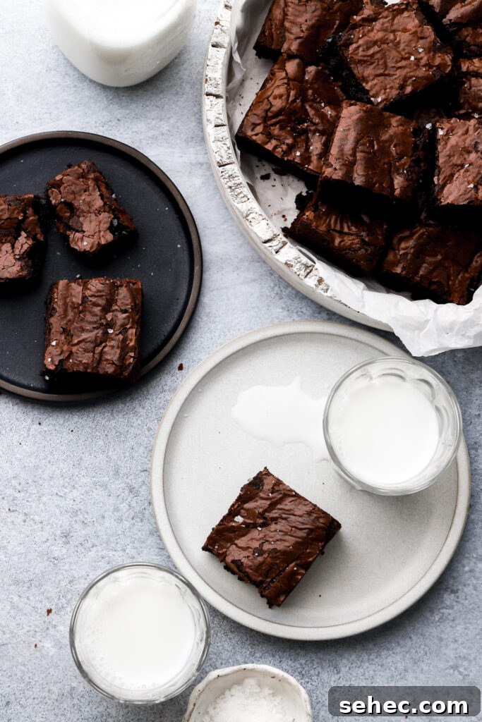 Fudgy Brown Butter Brownies with Crackly Tops 15 brown butter brownies on a plate with milk