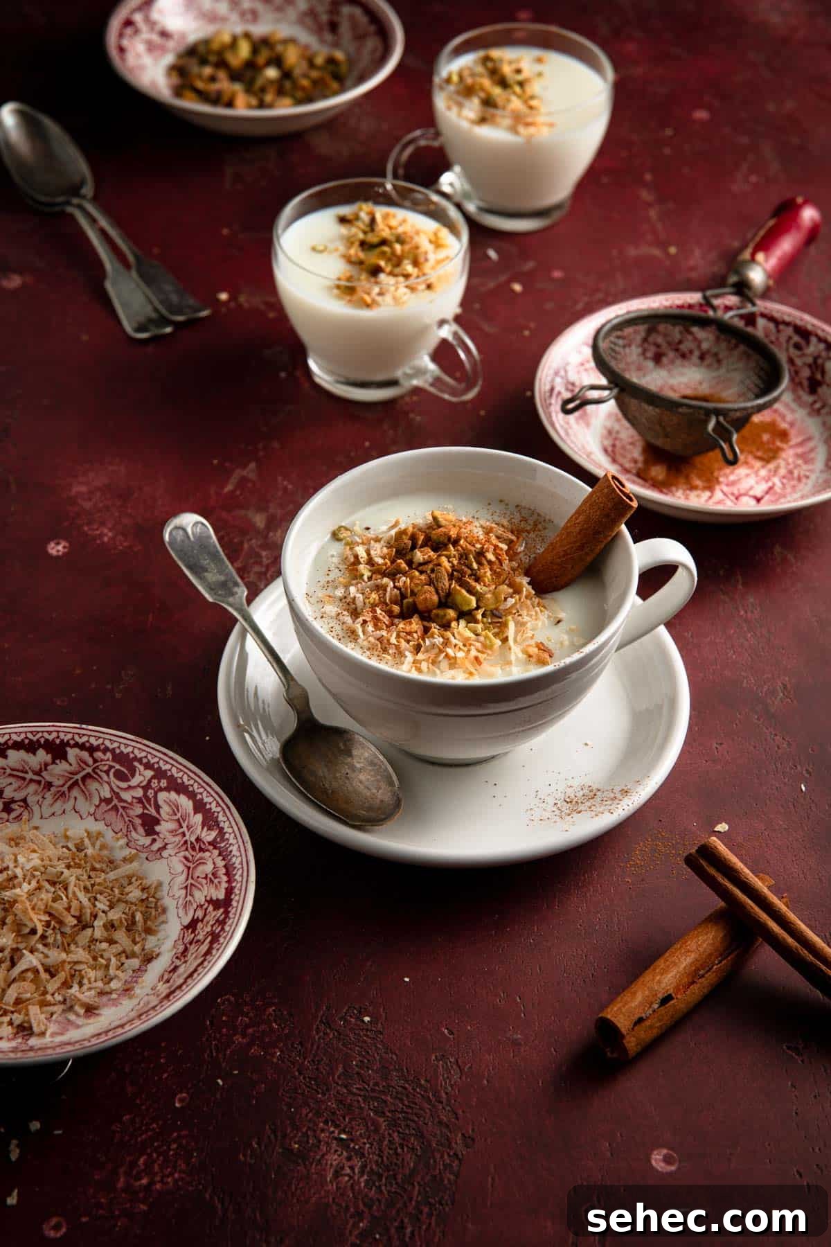 Creamy Sahlab Recipe for a Cozy Middle Eastern Drink 4 Cups with warm milk drink and bowls filled with toppings.