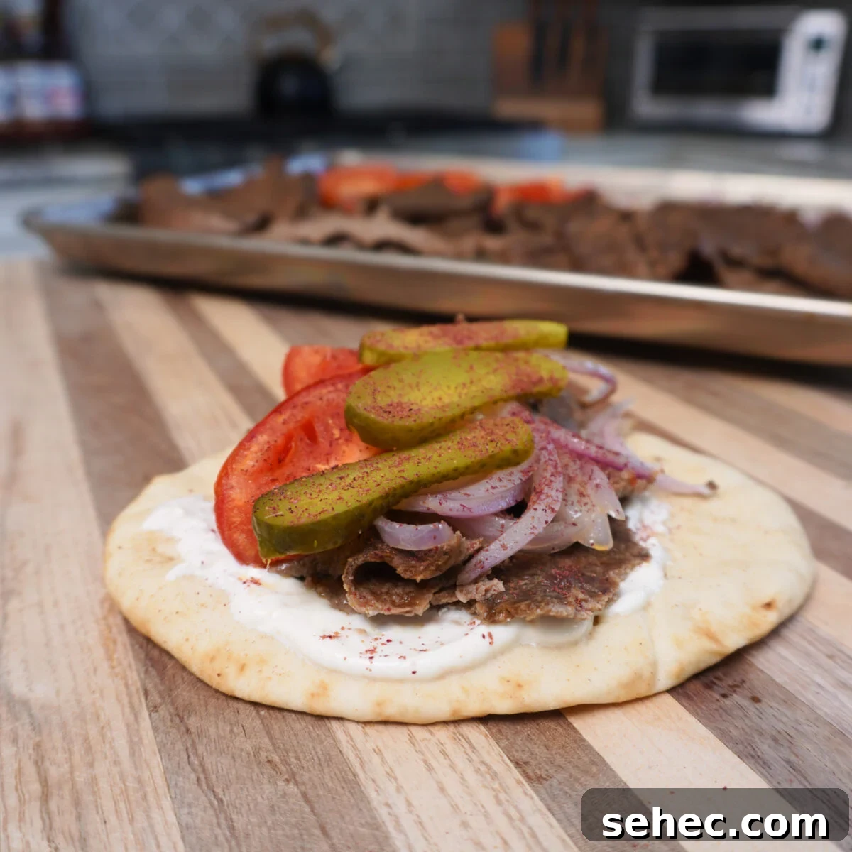 Sheet Pan Beef Kebabs with Vegetables 2 Sheet Pan Beef kebabs assembled on a cutting board.