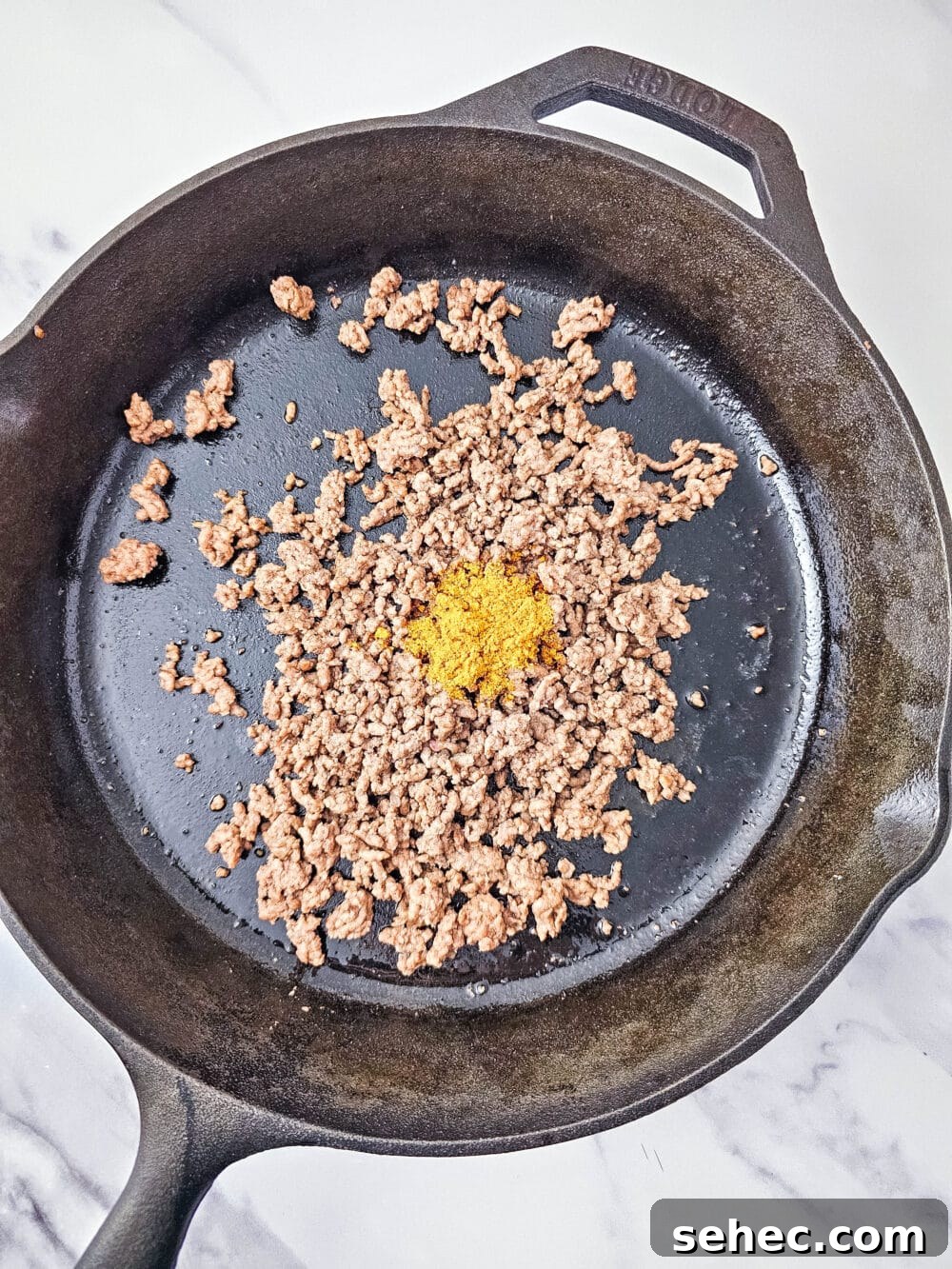 Cast Iron Skillet Pork Rind Nachos 7 Browned ground beef in a cast iron skillet with taco seasoning