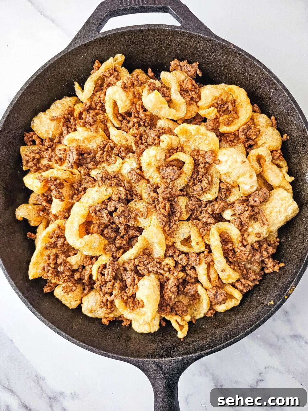 Cast Iron Skillet Pork Rind Nachos 9 Pork rinds and ground beef in a cast iron skillet