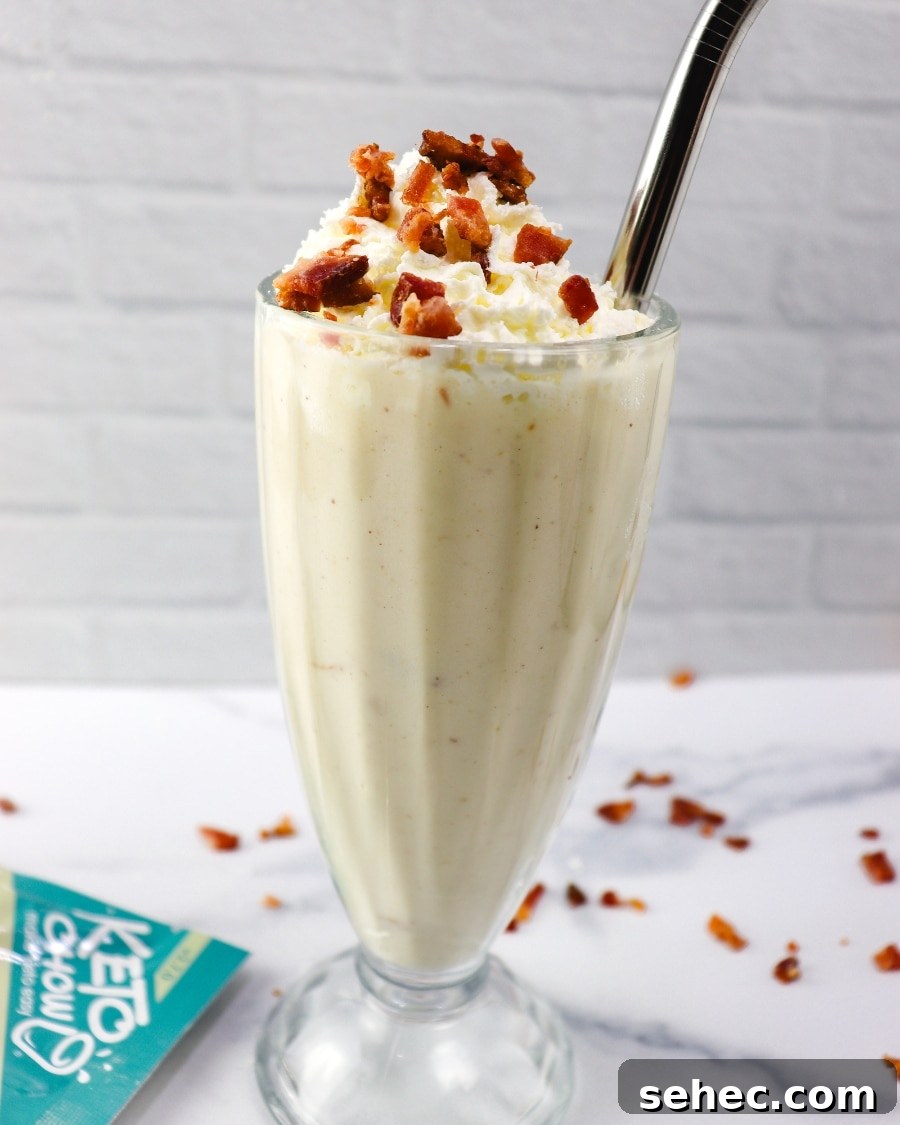 25 High Protein Low Carb Breakfast Ideas for Busy Mornings 10 A keto peanut butter bacon shake (copycat sonic recipe) served in a tall shake glass, topped with a generous dollop of whipped cream and sprinkled with crispy bacon bits. The shake sits on a clean, white countertop, offering a visually appealing contrast that highlights its creamy texture and unique combination of flavors.