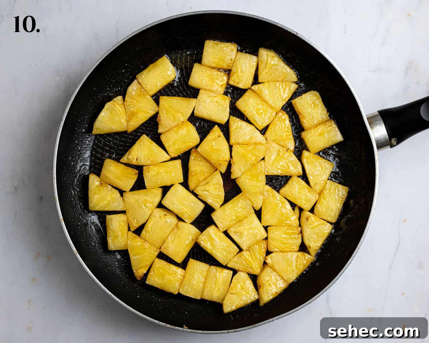 Vegan Caramelized Pineapple Coconut Tart 14 Cooked pineapple in a frying pan.