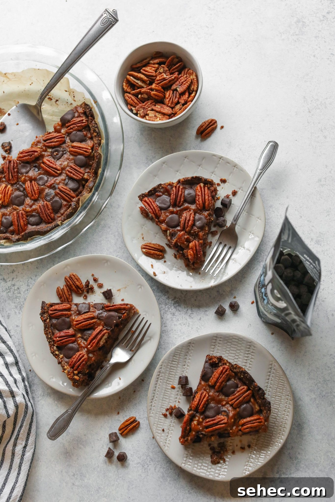 Vegan Dark Chocolate Pecan Pie Recipe 9 Vegan Dark Chocolate Pecan Pie sliced and plated with forks by Flora & Vino