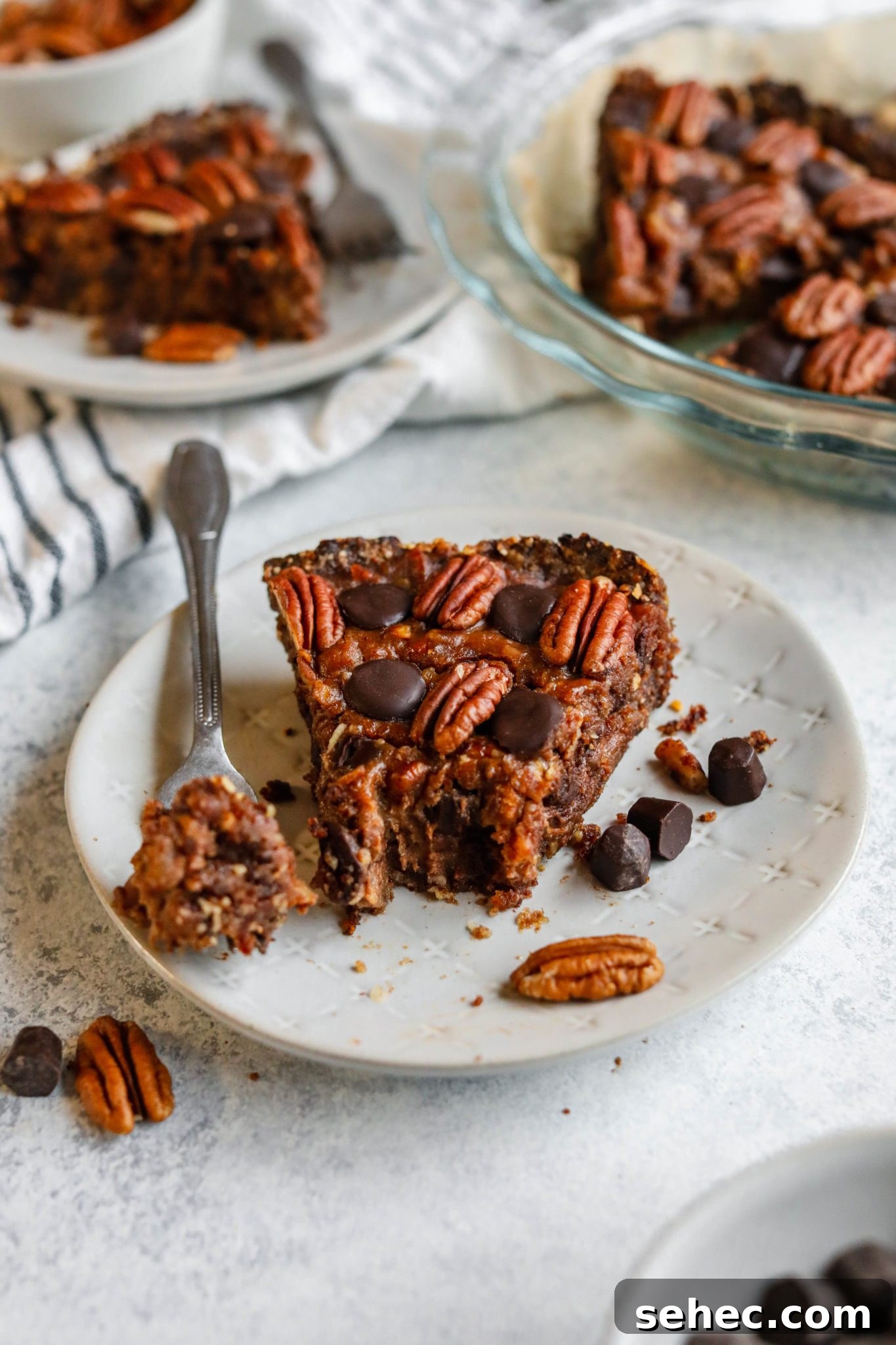 Vegan Dark Chocolate Pecan Pie Recipe 10 Vegan Dark Chocolate Pecan Pie slice plated with forkful by Flora & Vino