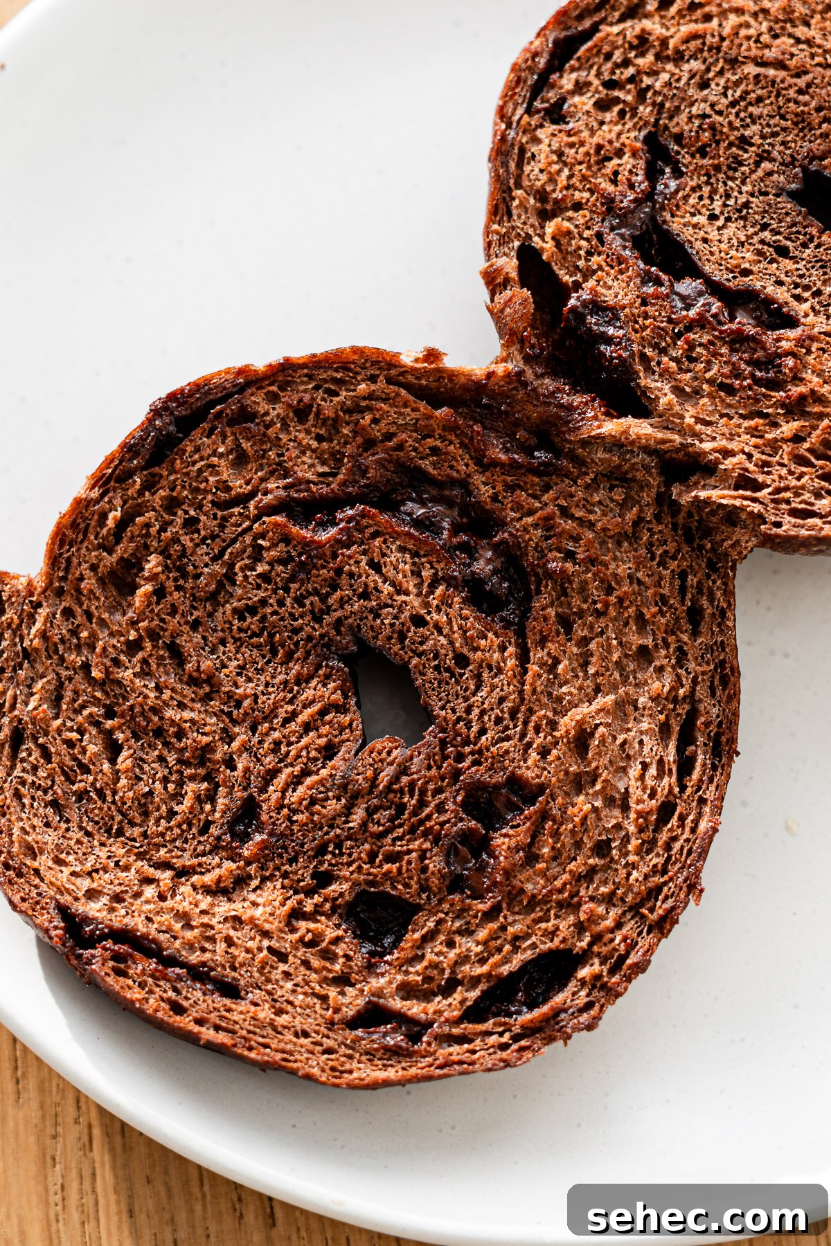 Homemade Chocolate Bagels with Rich Cocoa Flavor 5 cross section of chocolate chip chocolate bagel on a white plate