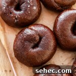 chocolate bagels on parchment paper on a pink tray