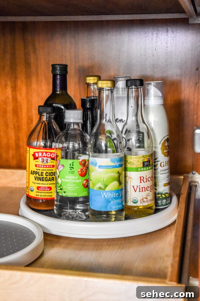 How to Play Pantry Cleanout Bingo and Declutter Your Kitchen 6 lazy susan in a pantry with vinegars on it.