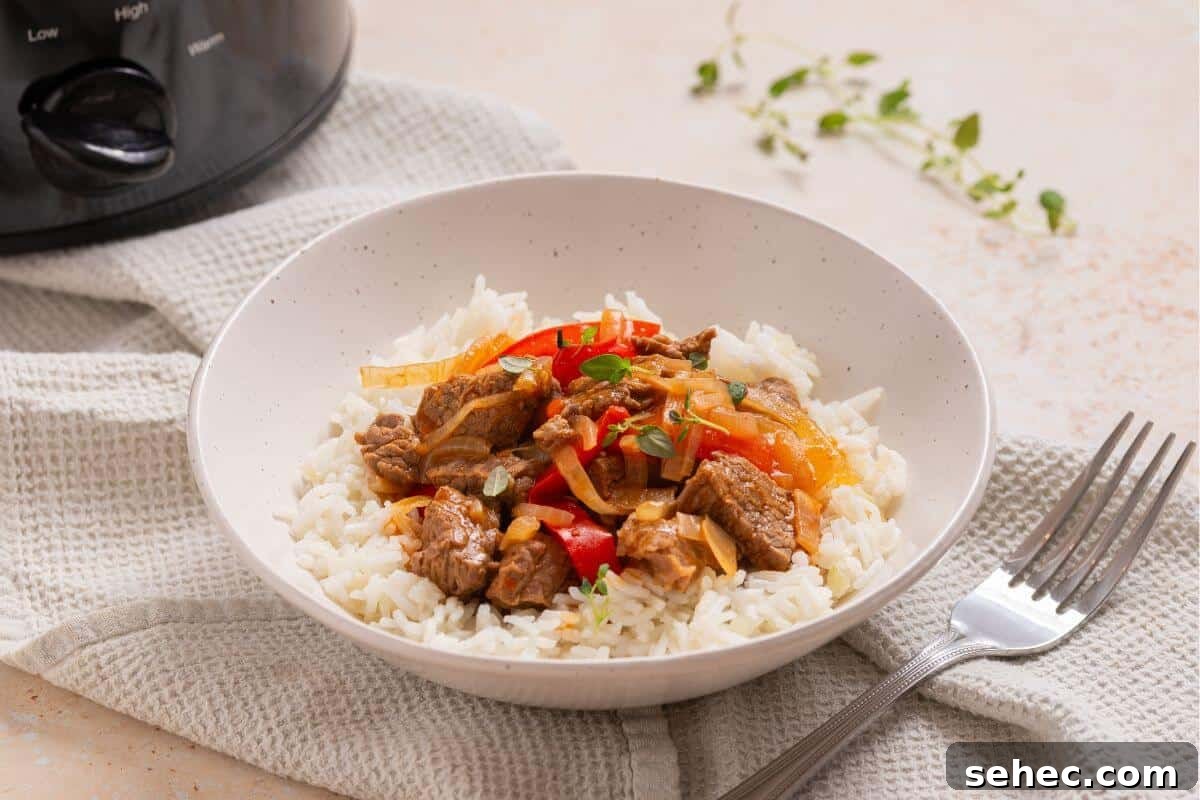 19 Weeknight Dinner Recipes You’ll Want to Cook Again 12 A bowl of rice with meat and peppers in front of a slow cooker.