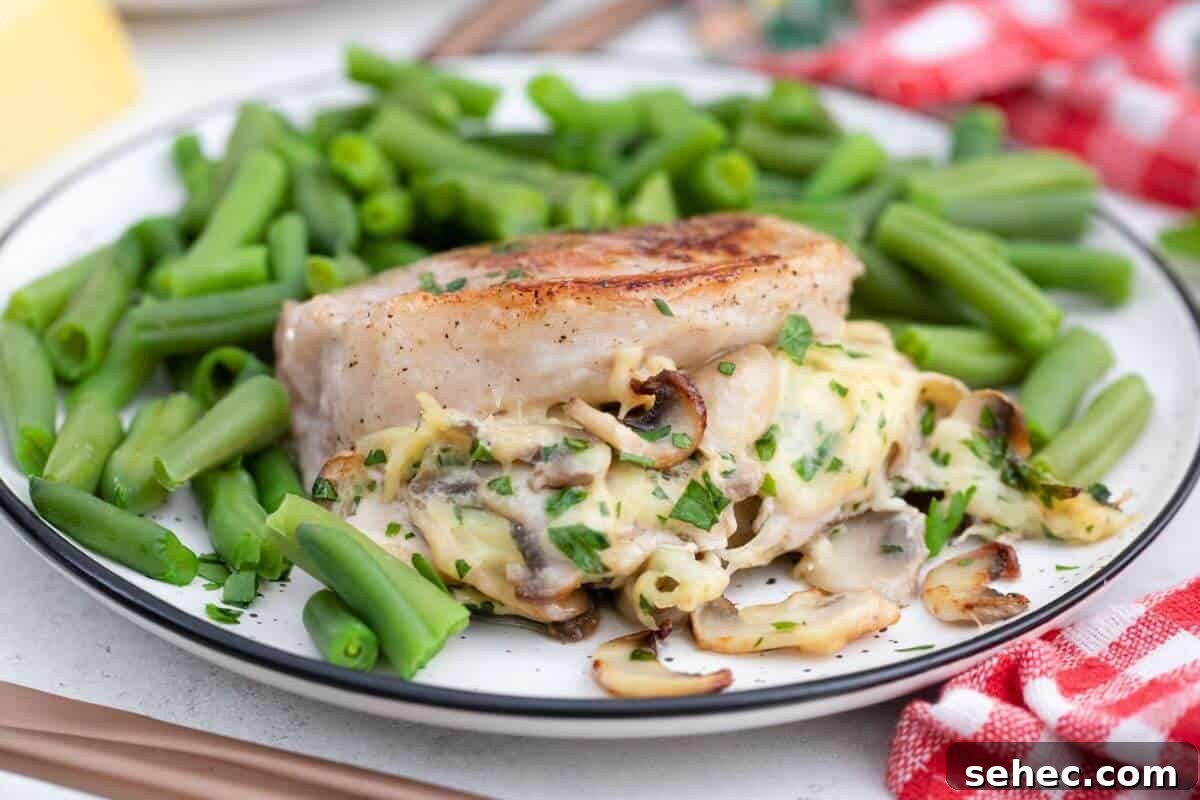 19 Weeknight Dinner Recipes You’ll Want to Cook Again 14 A plate of pork chops stuffed with mushrooms and cheese served with green beans.