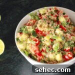 Zesty Quinoa Salad with Lemon Herb Dressing 4 Zesty Quinoa Salad in a white bowl with spoon; halved lemon to the side