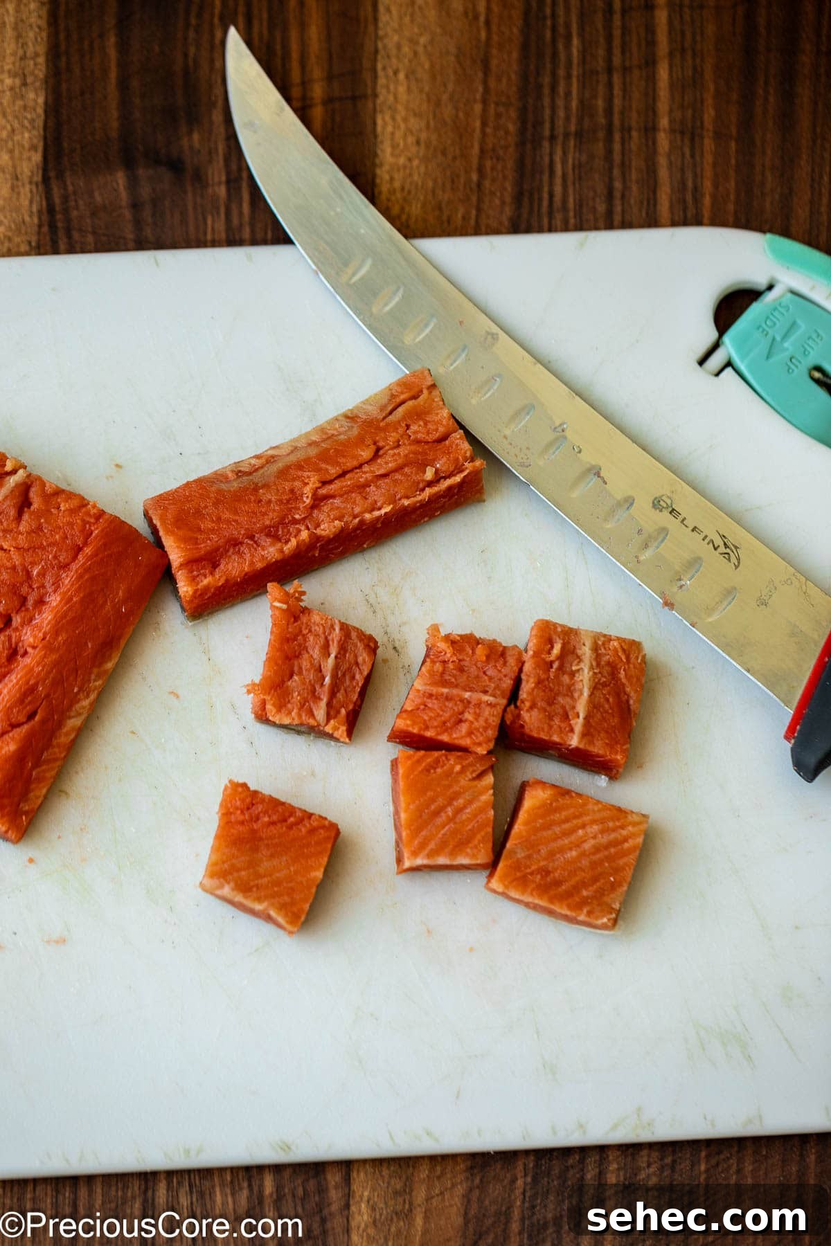 Creamy Cajun Salmon Pasta 6 Cutting salmon into bite-sized pieces.