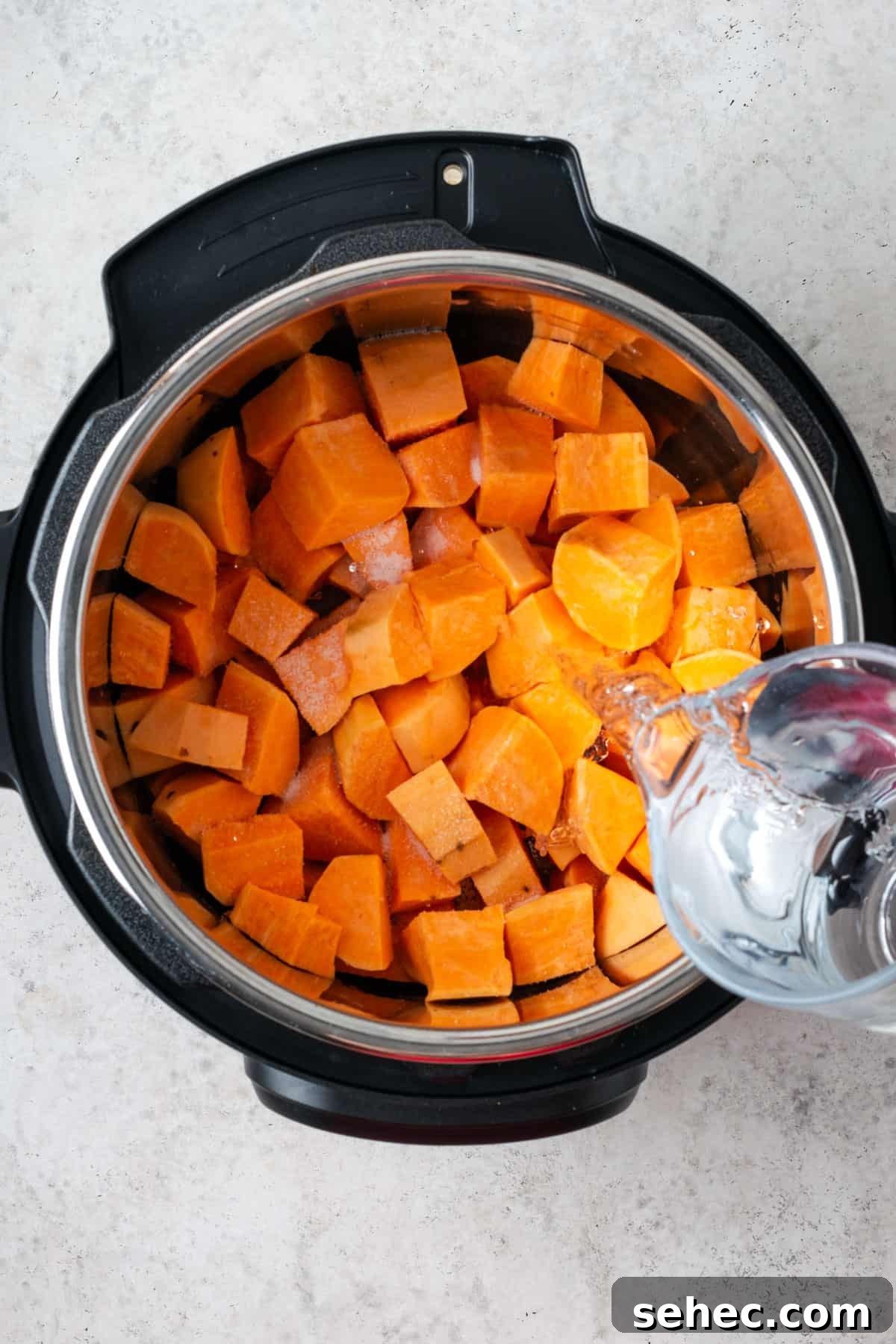 Creamy Instant Pot Mashed Sweet Potatoes 4 Sweet potatoes and water inside in Instant Pot.
