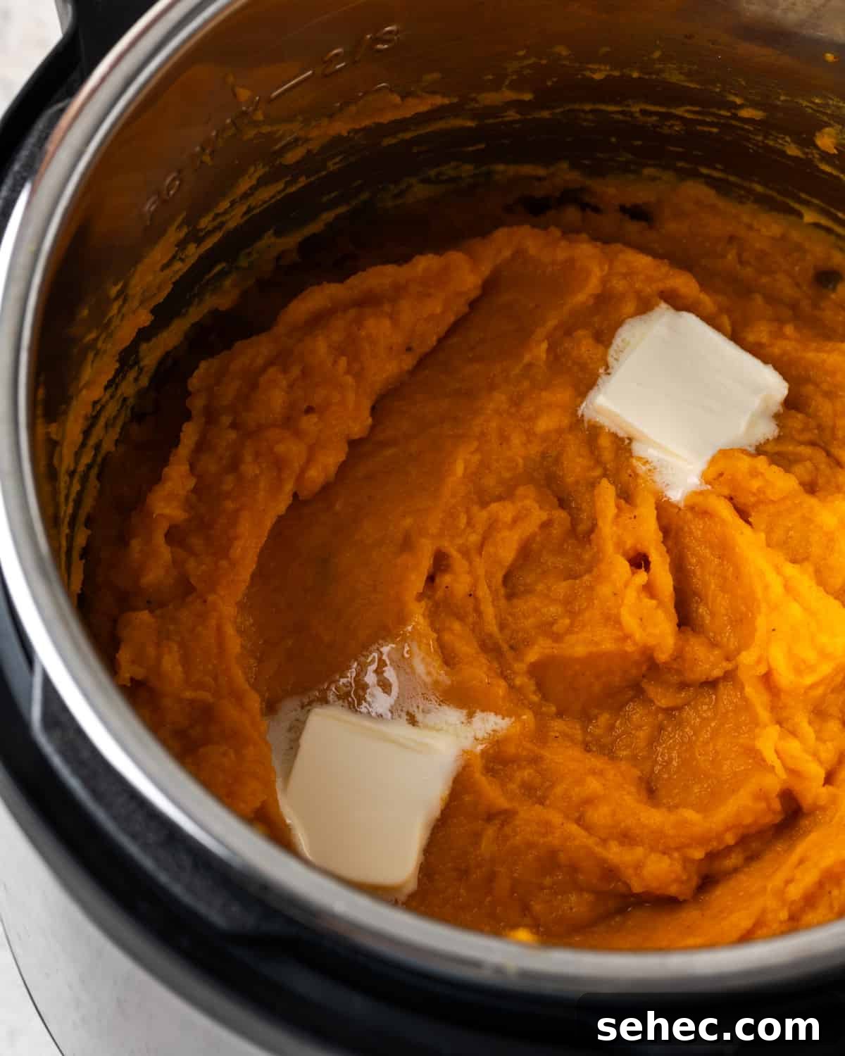 Creamy Instant Pot Mashed Sweet Potatoes 8 Mashed sweet potatoes topped with melting butter inside an Instant Pot.