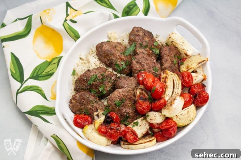 Sheet Pan Chicken Kebabs with Vegetables 2 Overhead view of a platter of kebab with onions and tomatoes.