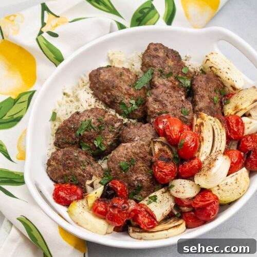 Sheet Pan Chicken Kebabs with Vegetables 9 Overhead view of a platter of kebab with onions and tomatoes.
