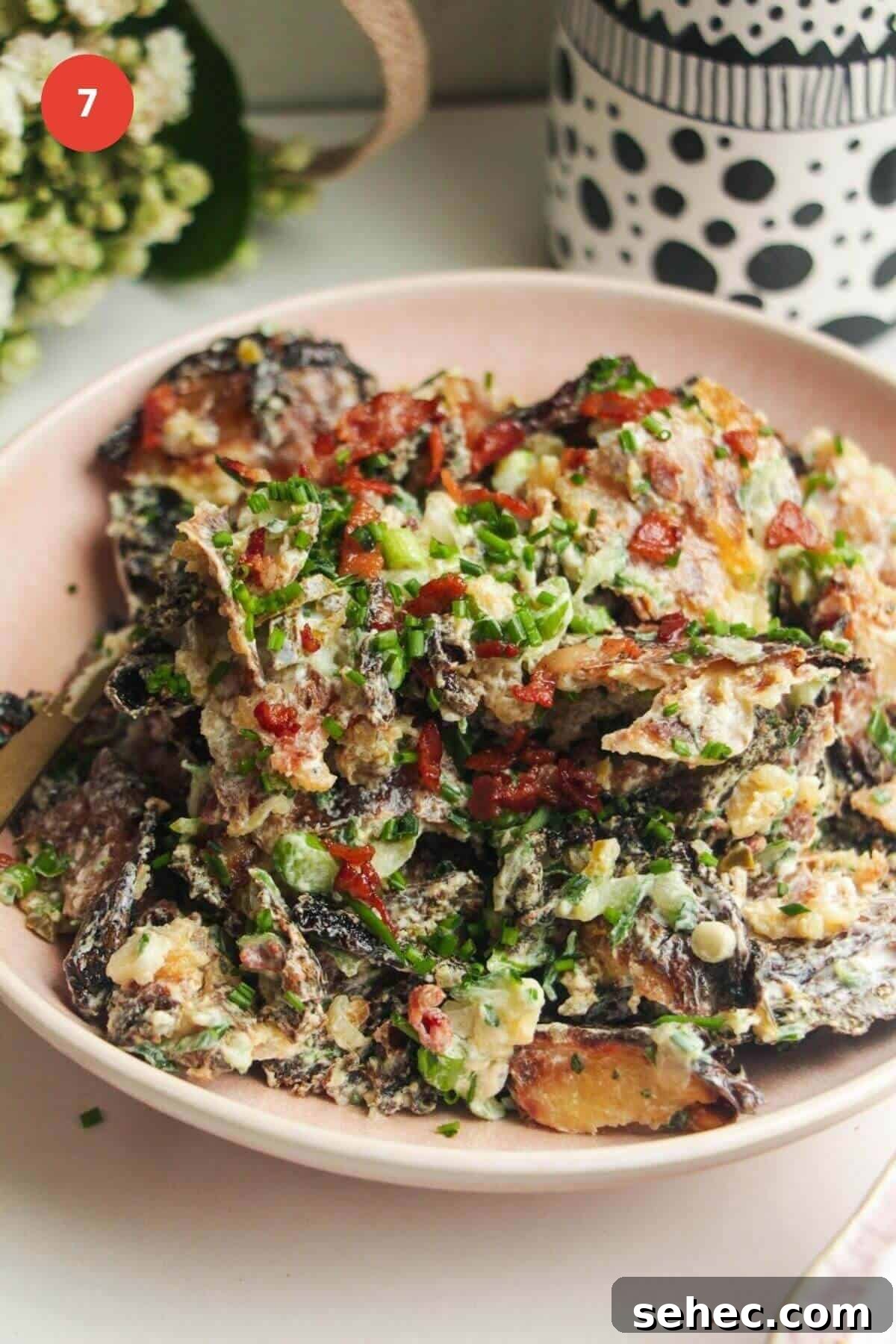 Crispy Smashed Potato Salad with Tzatziki Sauce 11 Smashed potato salad in serving bowl, with a spoon.