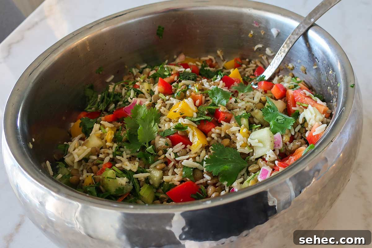 lentil and rice mixed with veggies, herbs and a light vinaigrette in a bowl