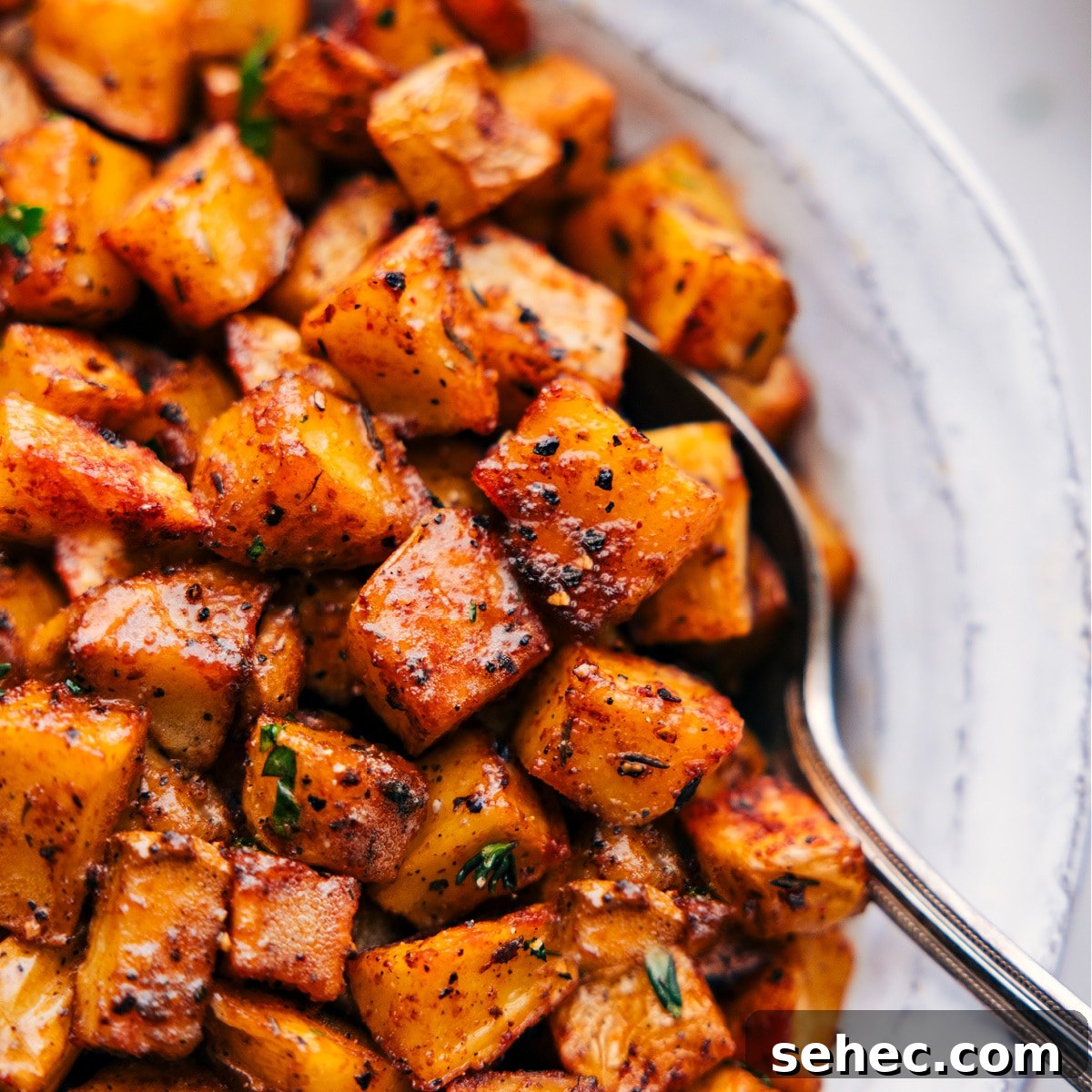 Up-close image of the Breakfast Potatoes with a spoon scooping them out.