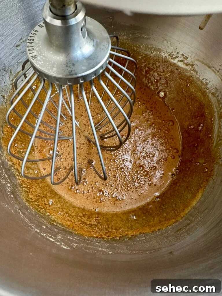 Brown Butter Buttercream Frosting Recipe 6 Brown sugar and egg whites inside a stand mixer bowl with whisk attachment.