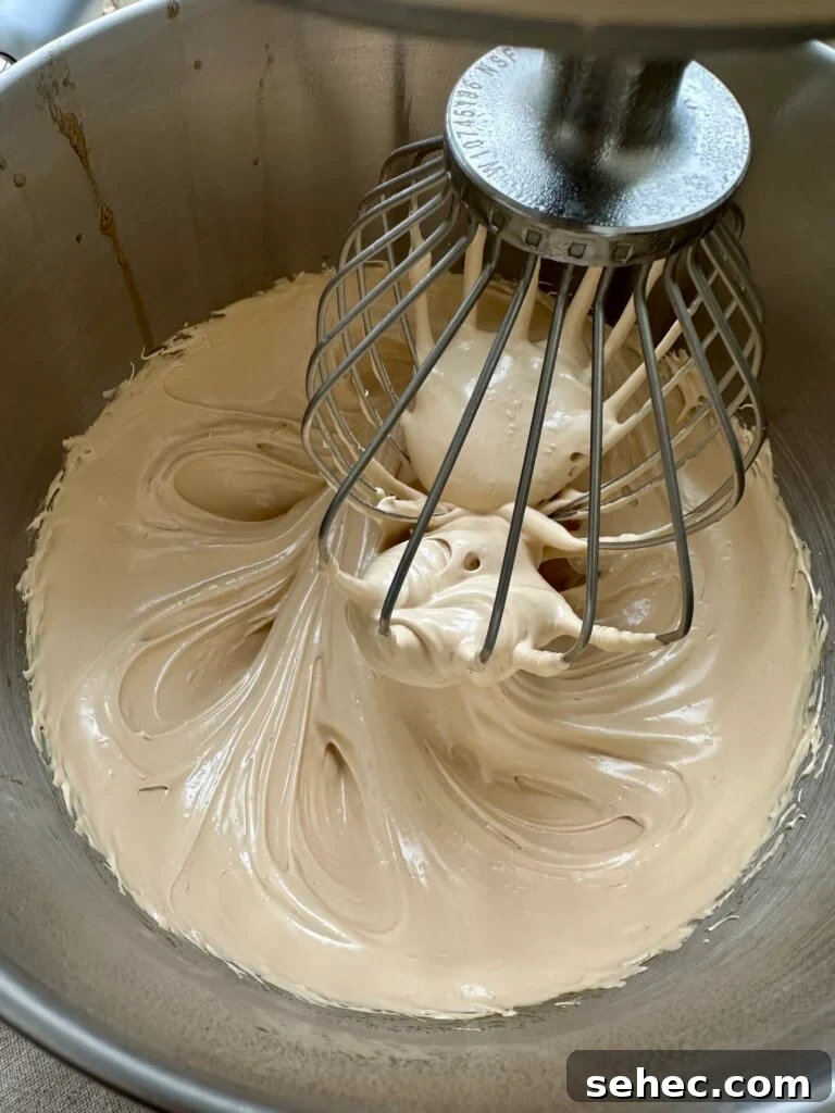 Brown Butter Buttercream Frosting Recipe 7 Whisk that is whipping meringue in a bowl.