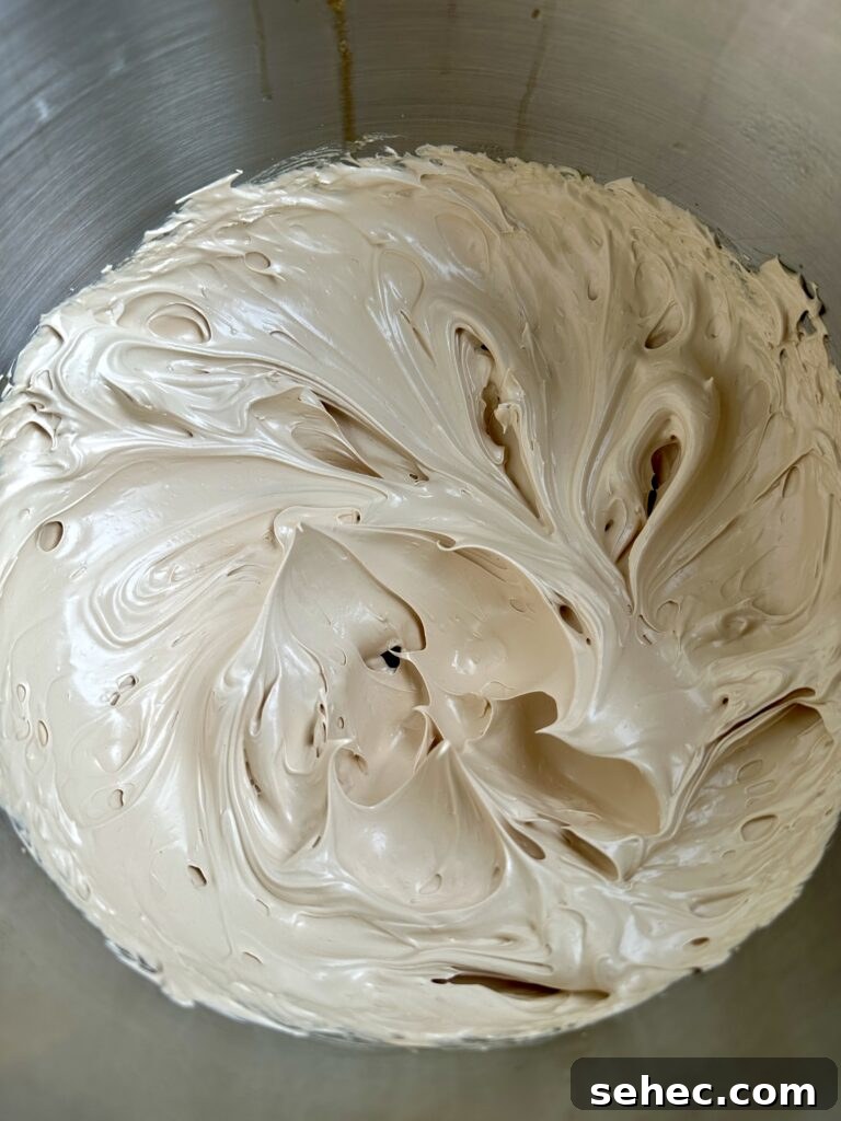 Brown Butter Buttercream Frosting Recipe 8 Stiff peak brown sugar meringue in a mixing bowl.