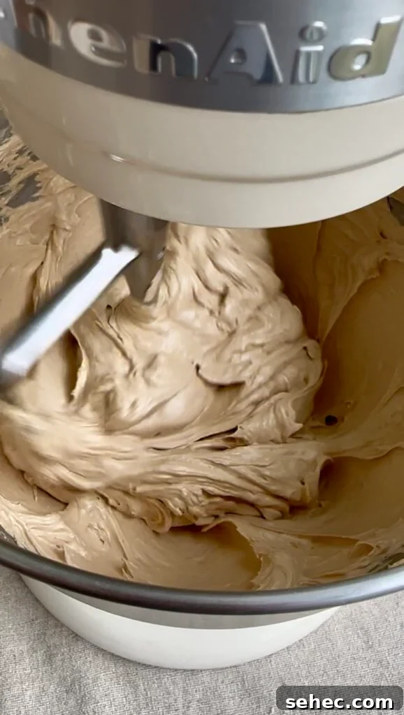 Brown Butter Buttercream Frosting Recipe 9 Brown sugar frosting in a mixing bowl with paddle attachment.