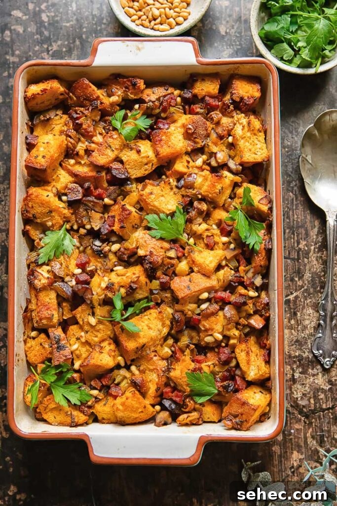 Chorizo and Fig Stuffing Recipe for Thanksgiving 2 Top down shot of chorizo stuffing in a baking dish topped with fresh parsley