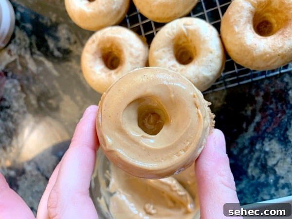 Gluten-Free Peanut Butter Donuts Recipe 10 Holding up a donut with peanut butter icing.