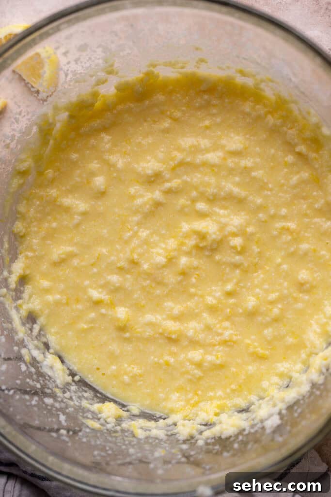Lemon Curd Cake with a Soft Buttery Crumb 4 Wet ingredients in a glass bowl.
