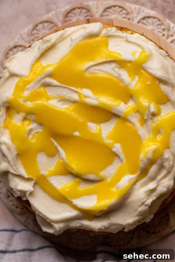 Lemon Curd Cake with a Soft Buttery Crumb 10 Lemon curd on top of the cake.